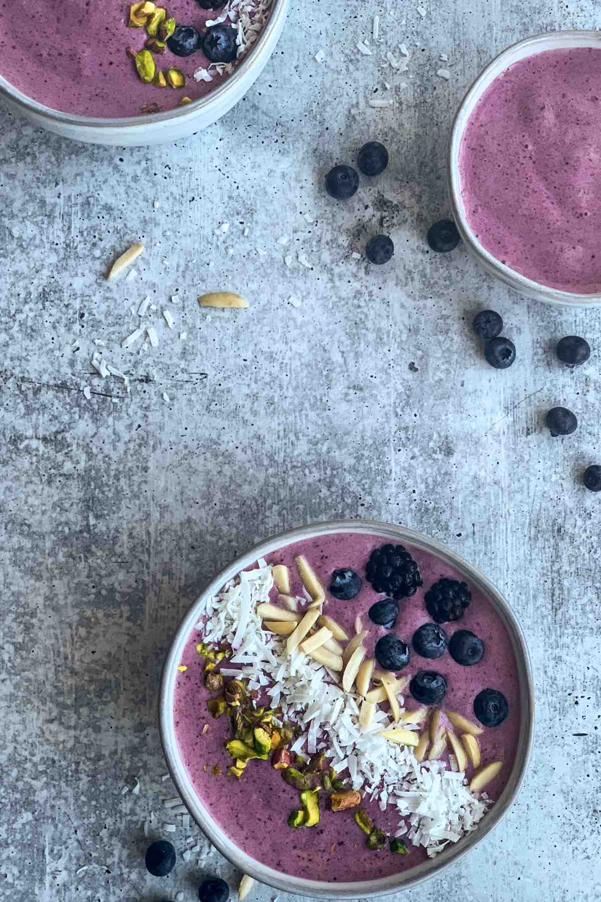 Blackberry smoothie bowl with toppings overhead shot.