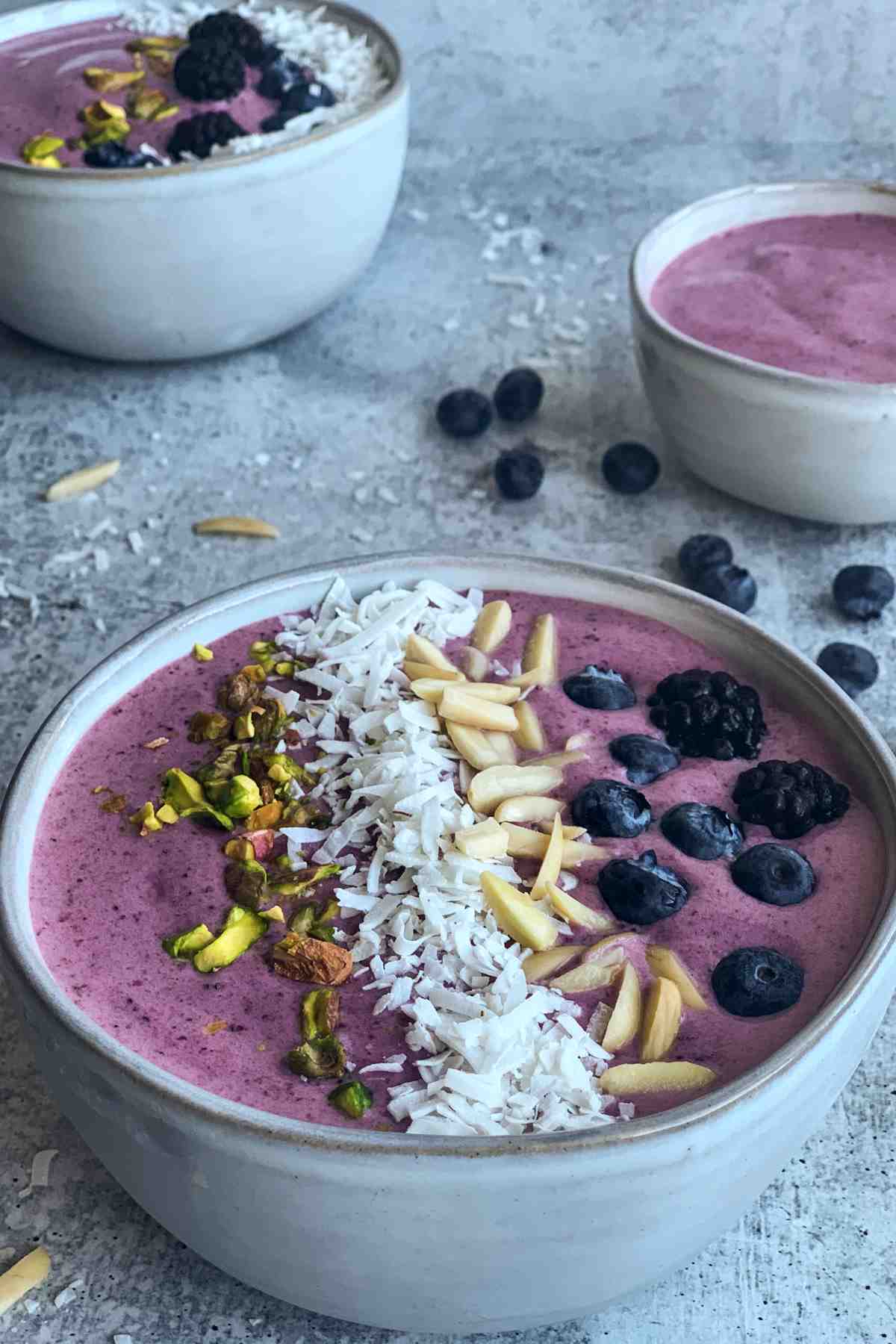 Blackberry smoothie bowl with toppings.