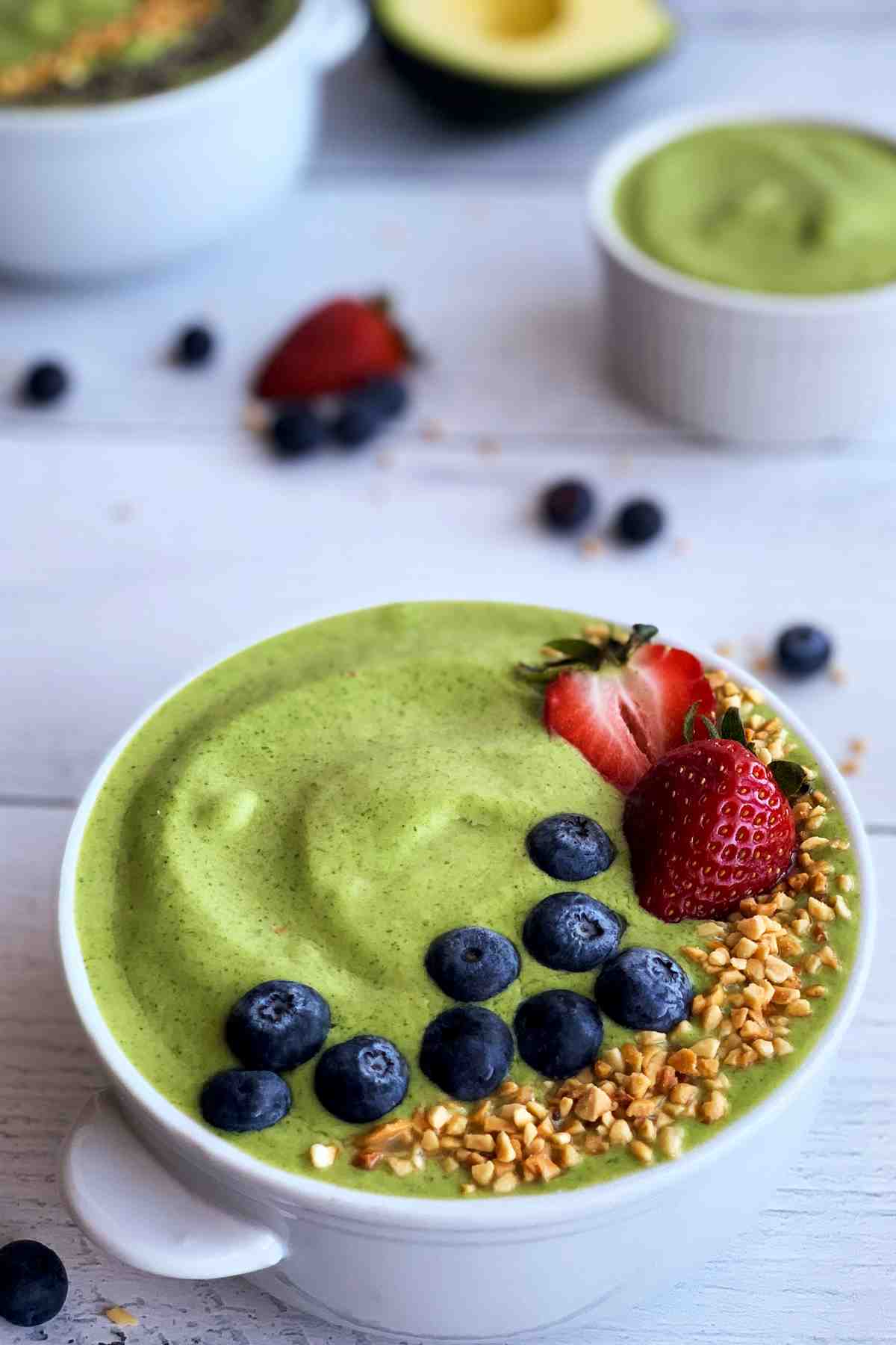 Green smoothie bowl closeup with toppings.