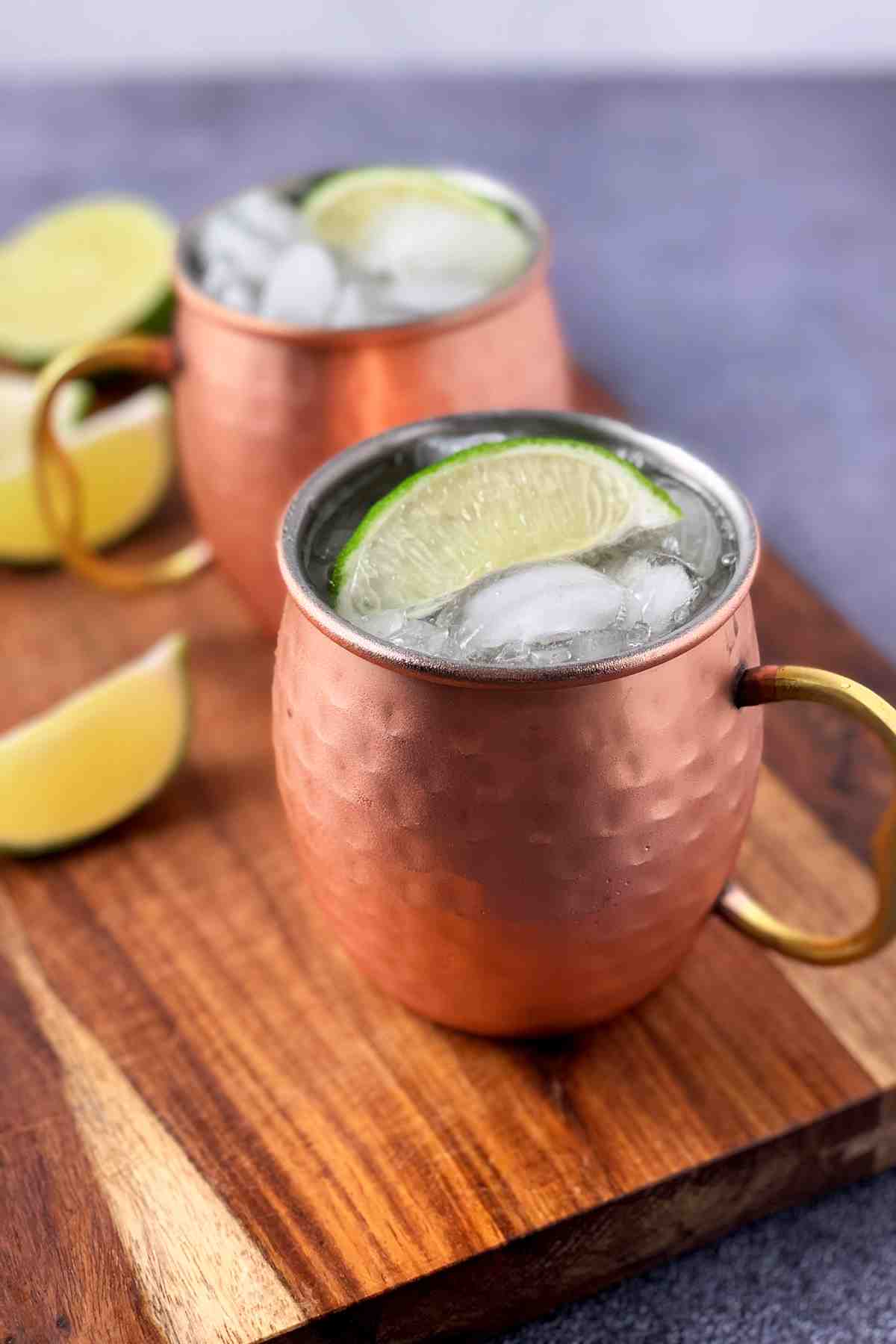 Moscow mule in a copper mug with lime wedge.