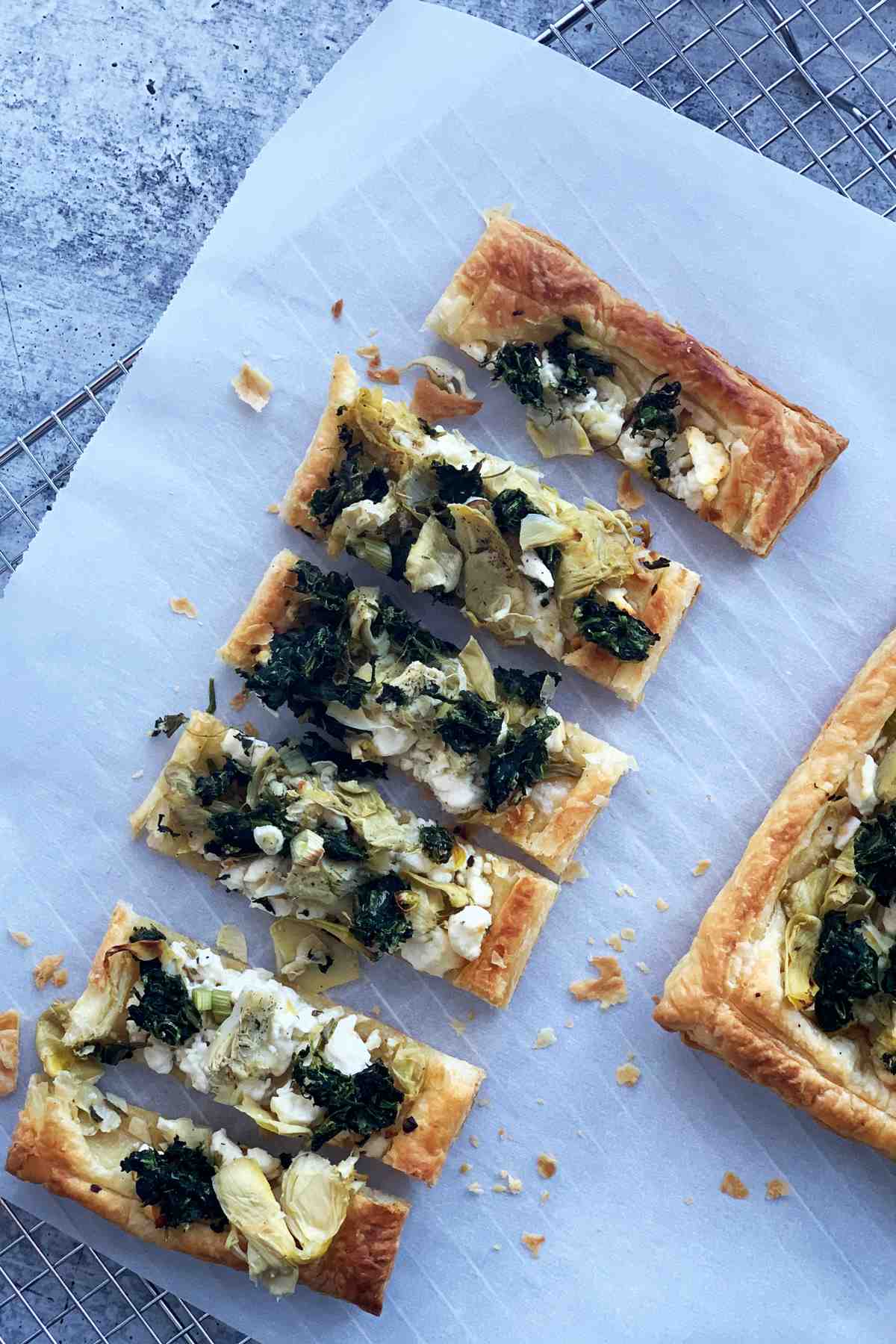 Puff pastry flatbread with spinach and artichoke.