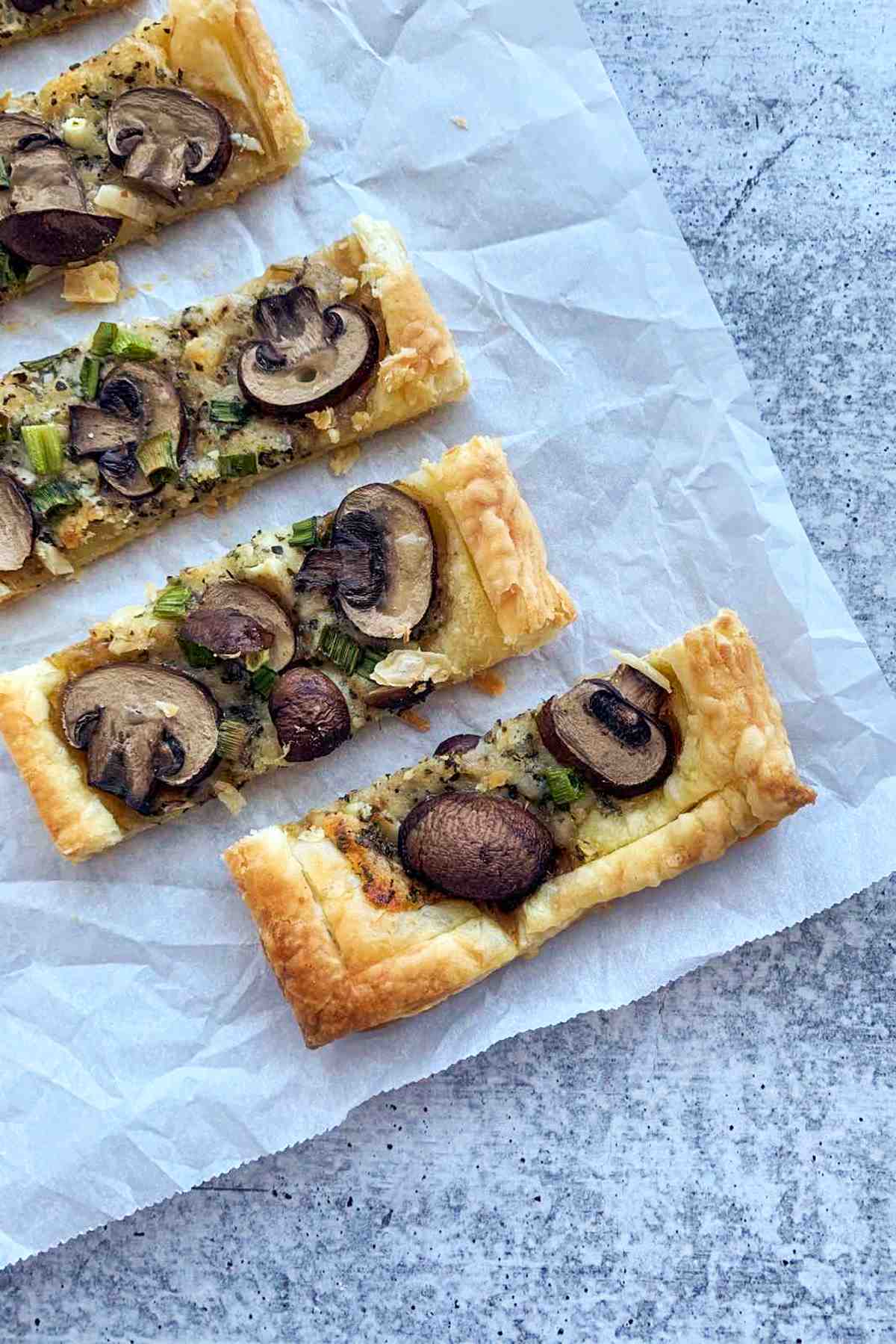 Baked puff pastry flatbread with mushrooms overhead.