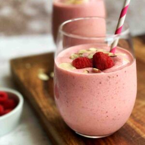 Strawberry raspberry smoothie with toppings.