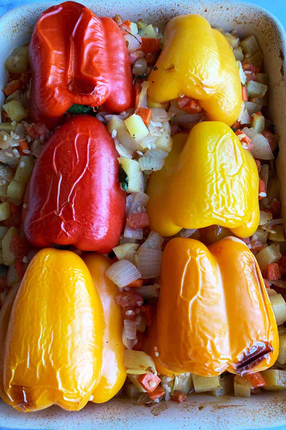 Baked stuffed bell peppers in a dish.