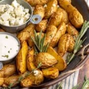 Air fryer fingerling potatoes in metal tray close up.