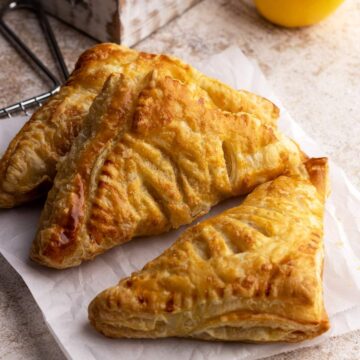 Apple turnovers on a wire rack.