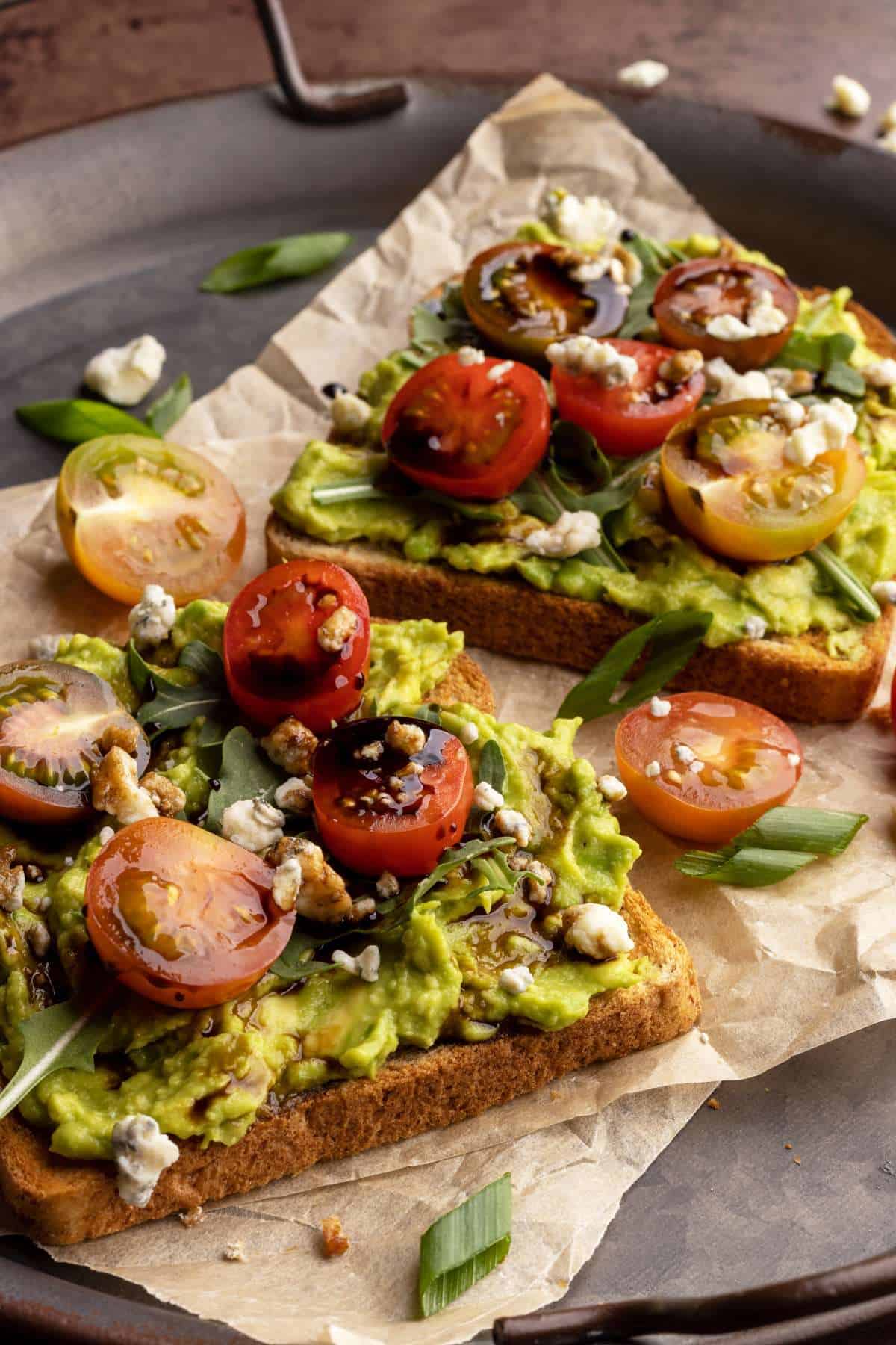 Avocado toast with cherry tomatoes and balsamic glaze.