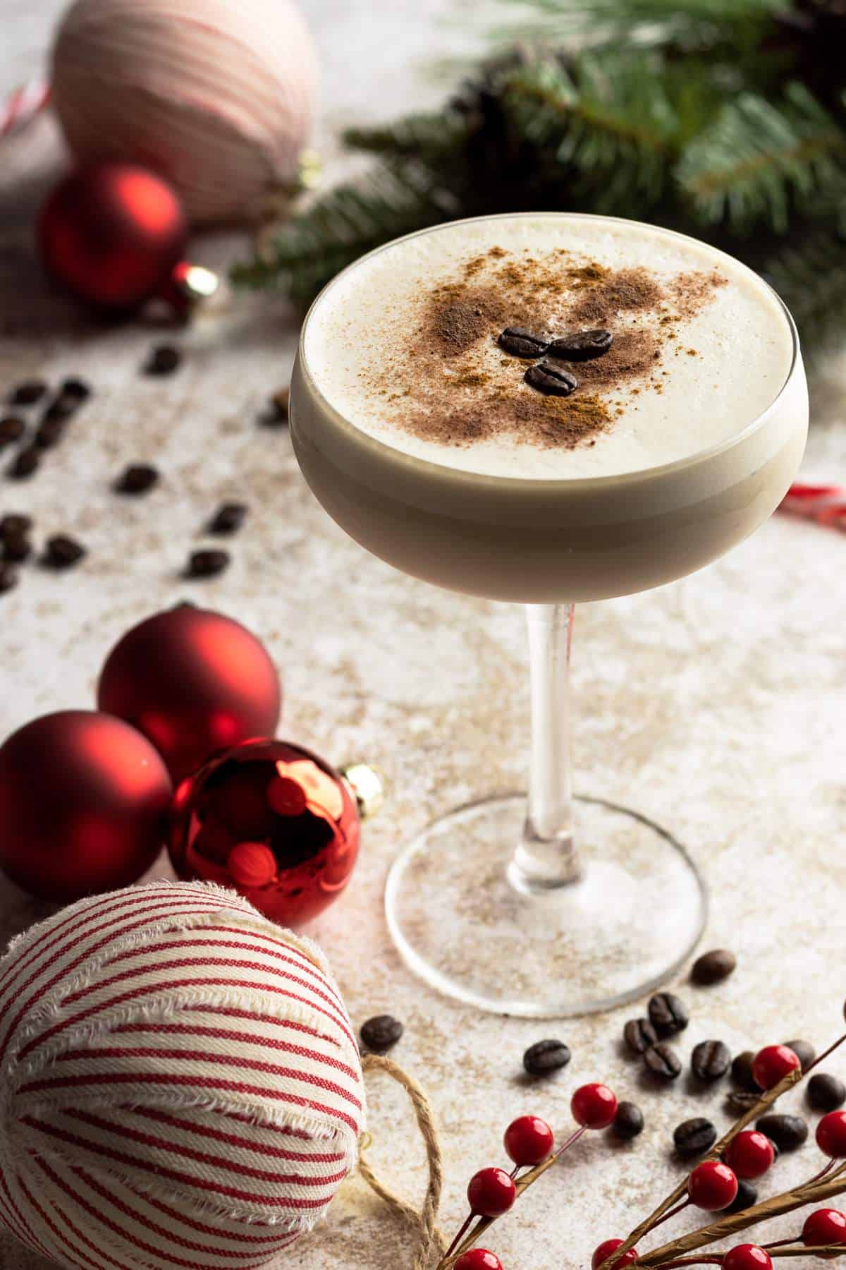 Baileys espresso martini in a glass with coffee beans garnish.