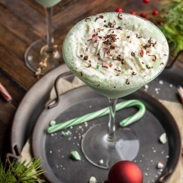 Baileys mint martini in a glass with whipping cream.
