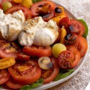 Burrata salad with balsamic glaze on a plate.