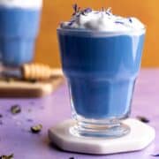 Butterfly pea latte in a glass mug.