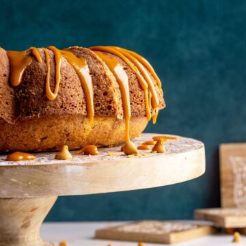 Butterscotch rum cake on a cake stand head-on shot.