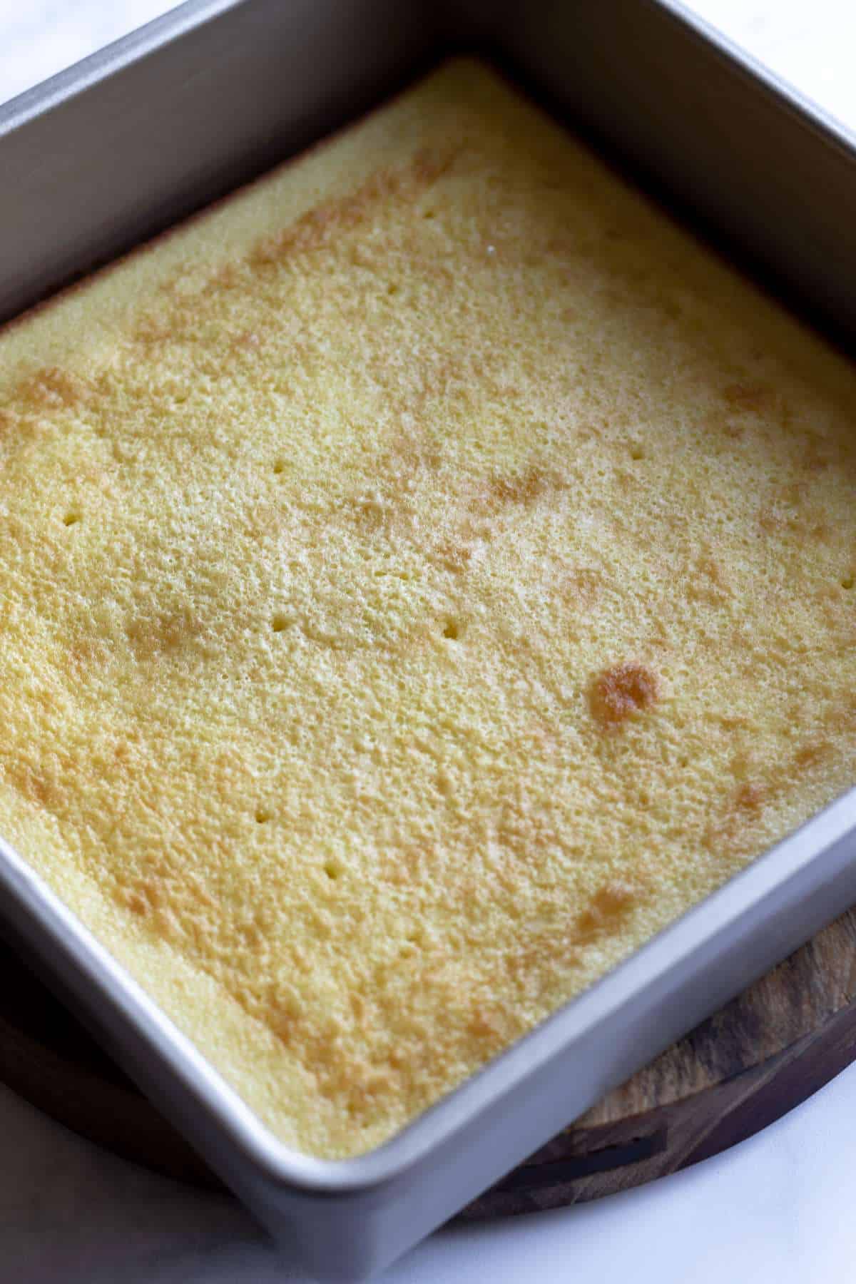 Baked cake layer in a dish.