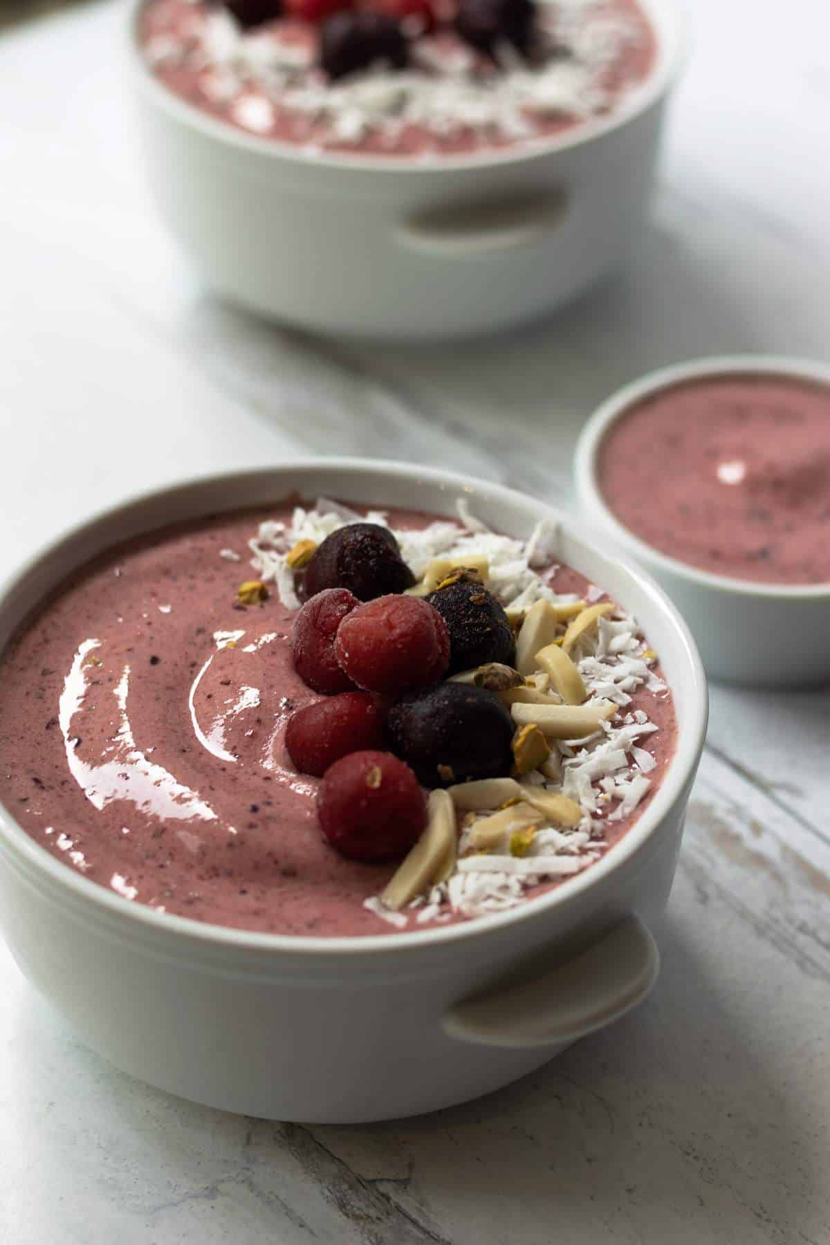 Cherry smoothie bowl with fruit toppings.