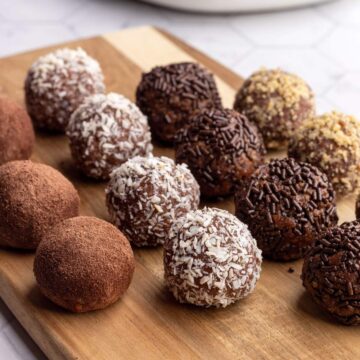 Chocolate truffles on a wooden board.