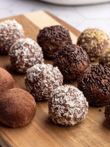 Chocolate truffles on a wooden board.