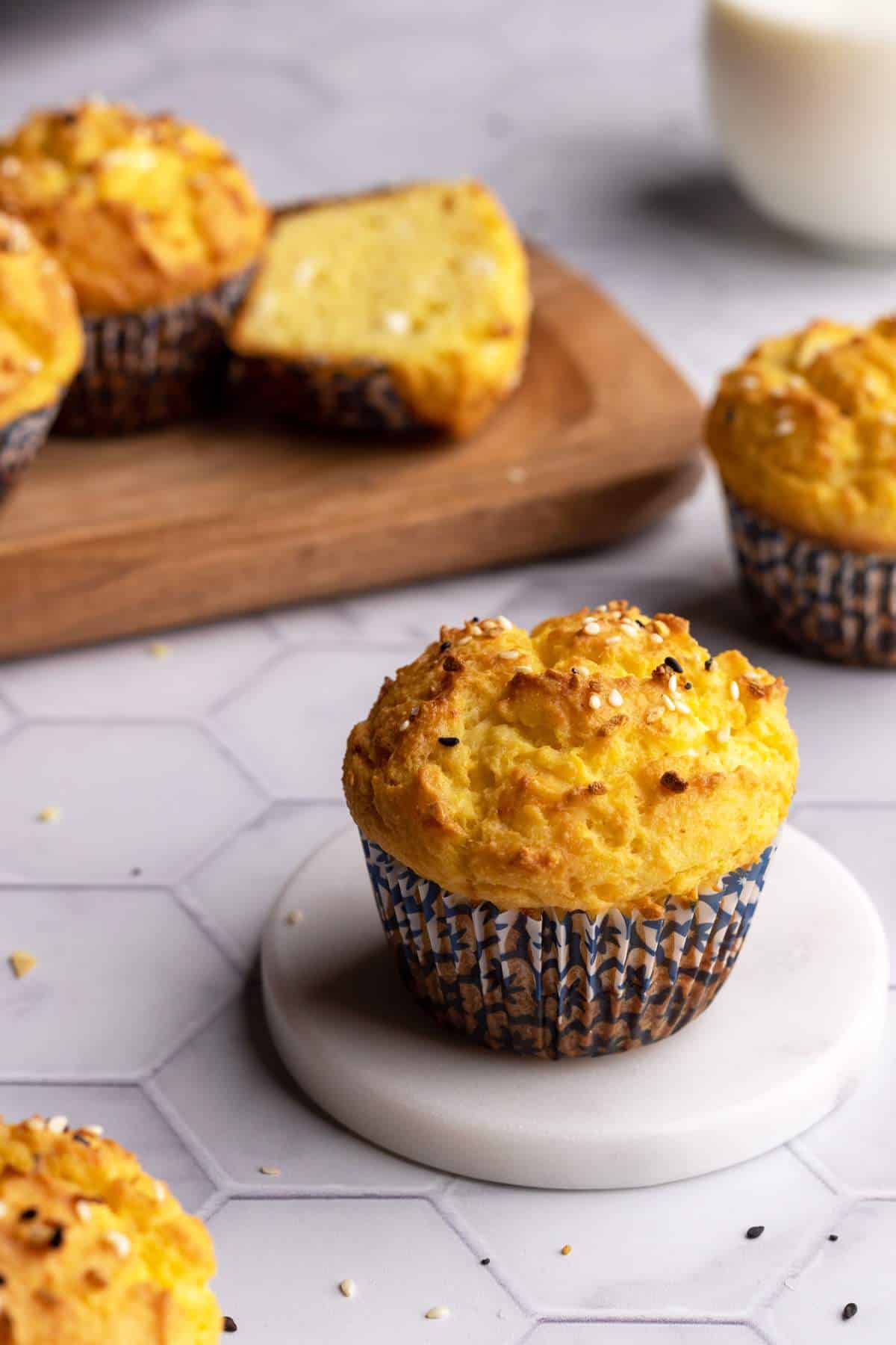 Cornbread muffin in a baking cup on a coaster.