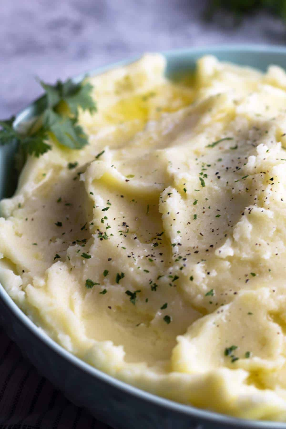 Creamy mashed potatoes in a bowl close-up shot.