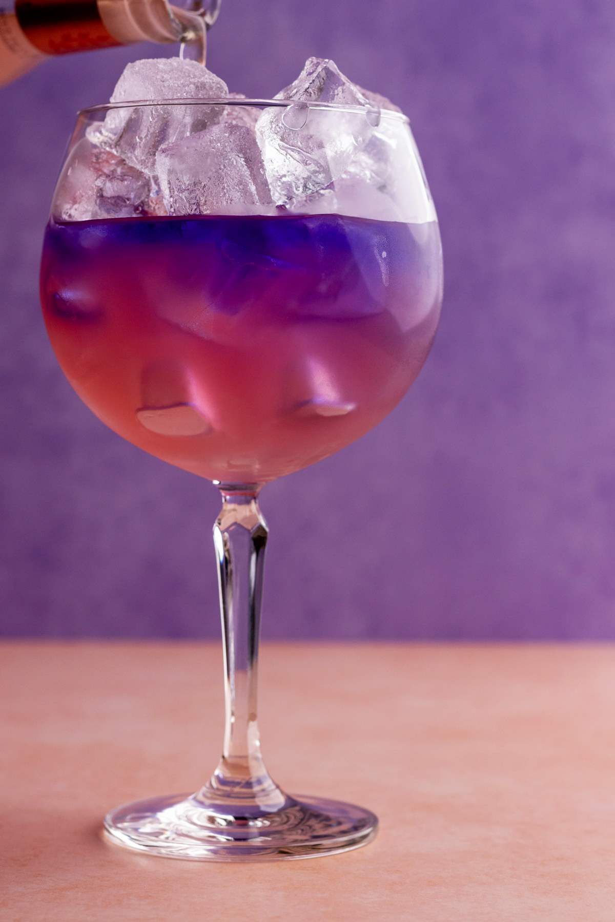 Empress gin cocktail pouring pink grapefruit.