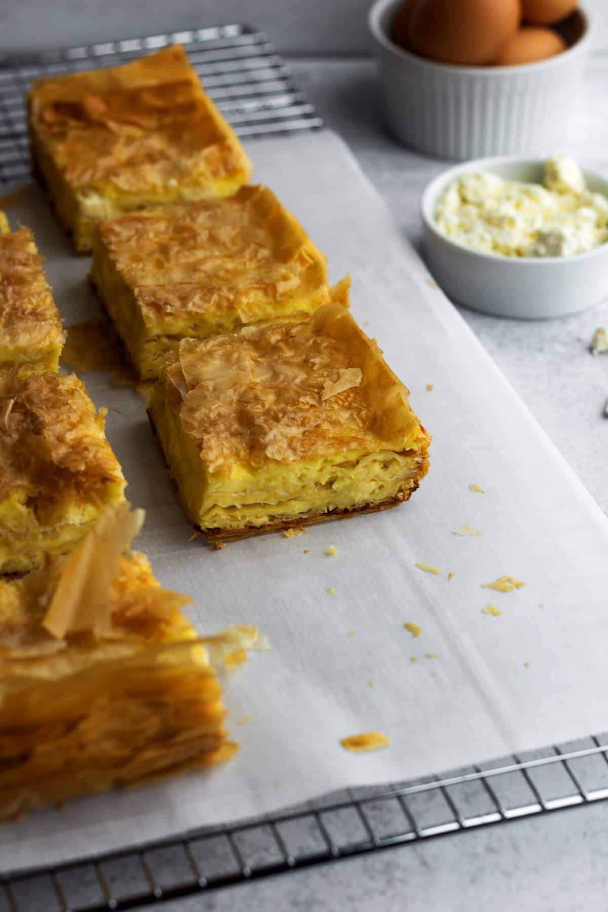 Gibanica cheese pie pieces on a wire rack.