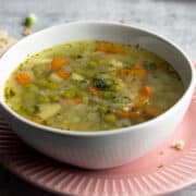 Green peas soup in a bowl on a plate.