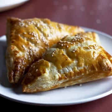 Puff pastry turnovers on a plate.