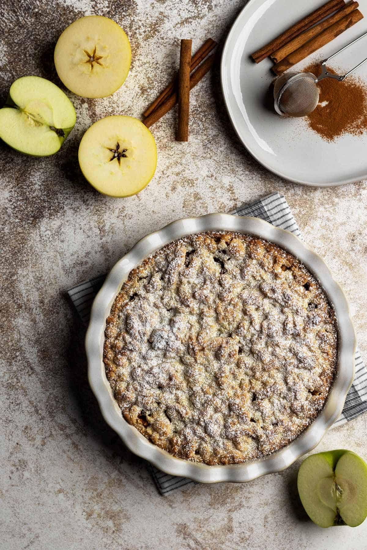 Baked apple pie with powdered sugar overhead shot.