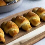 Homemade crescent rolls on a cutting board close-up shot.