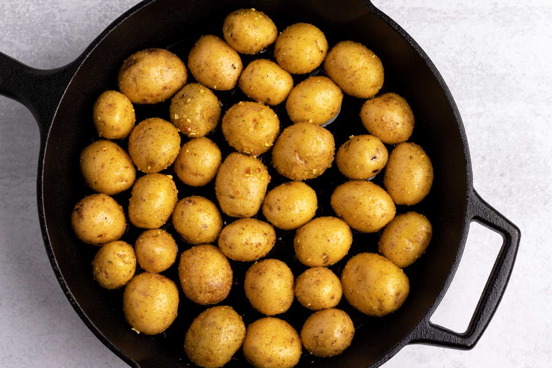 Oven roasted potatoes in a cast iron skillet.