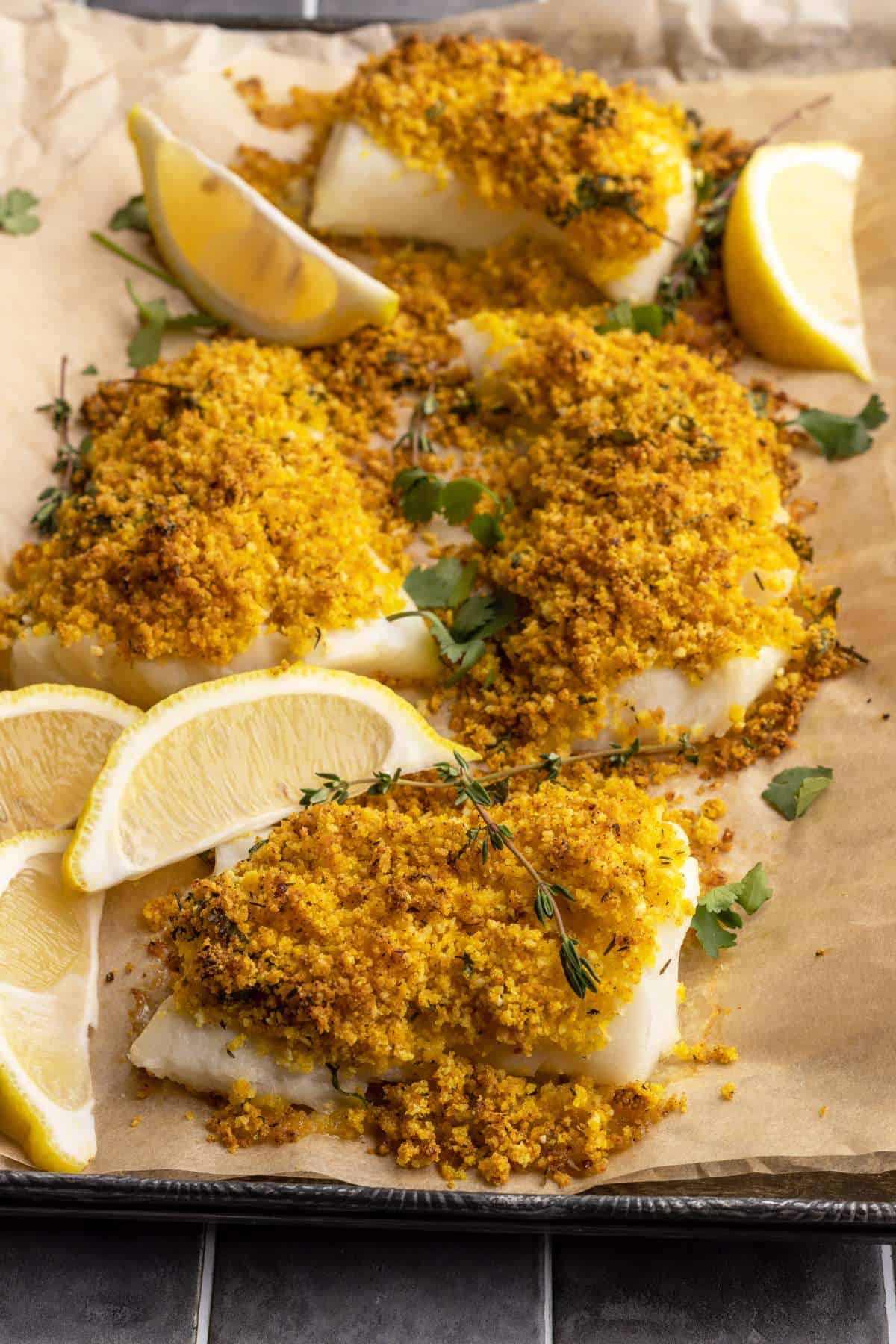 Panko crusted cod with lemon wedges.