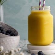 Pineapple mango smoothie in a jar head-on shot.
