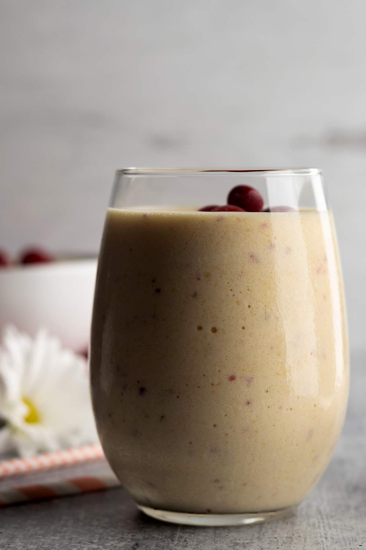 Pineapple peach smoothie in a glass.