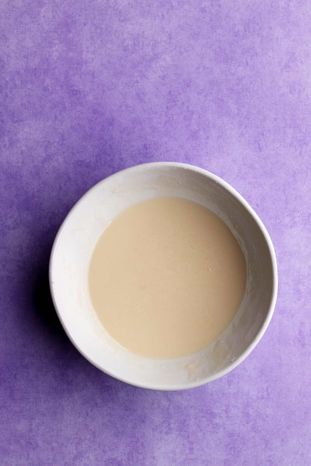 Powdered sugar glaze in a small bowl overhead shot.