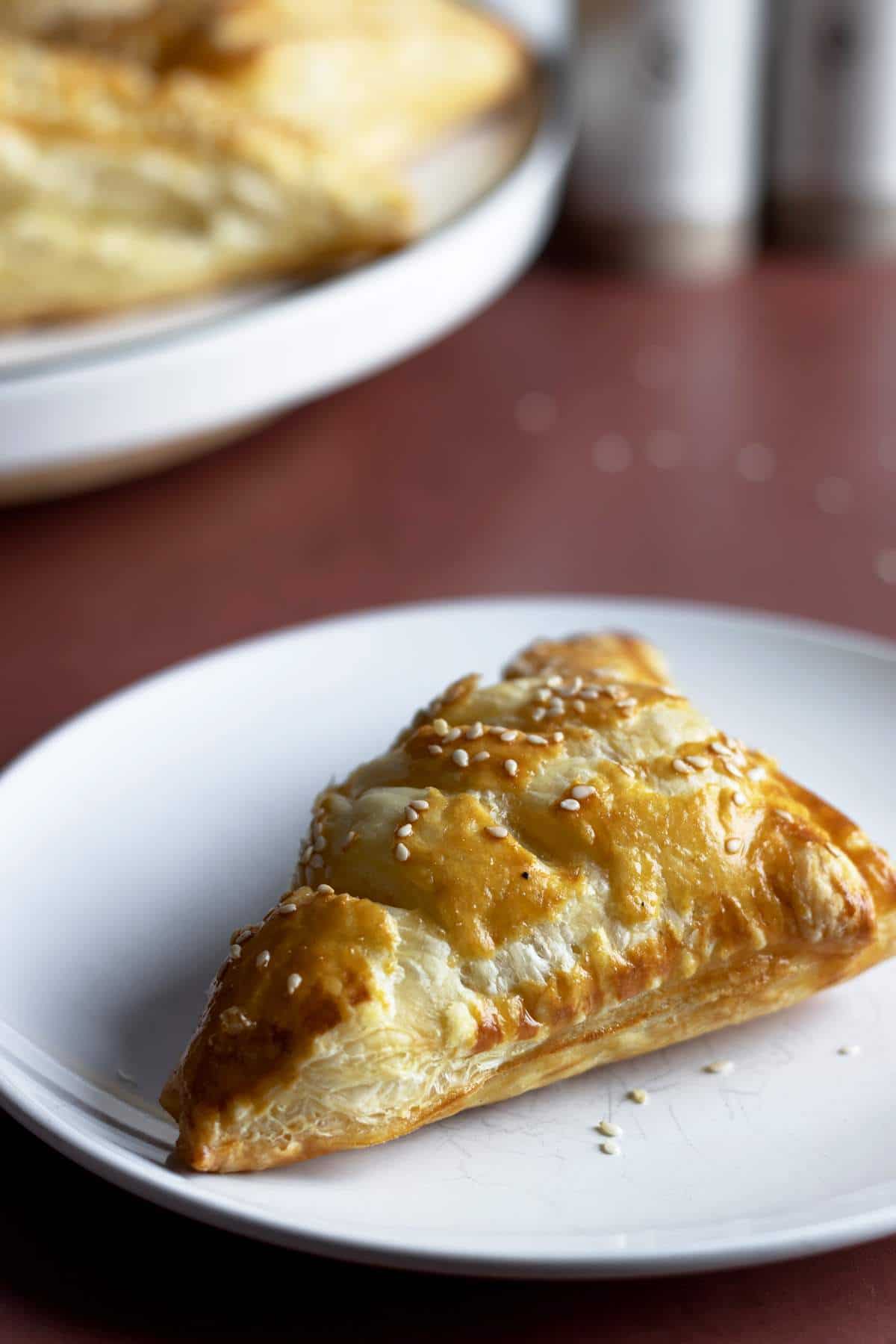 Puff pastry turnovers on a small plate.