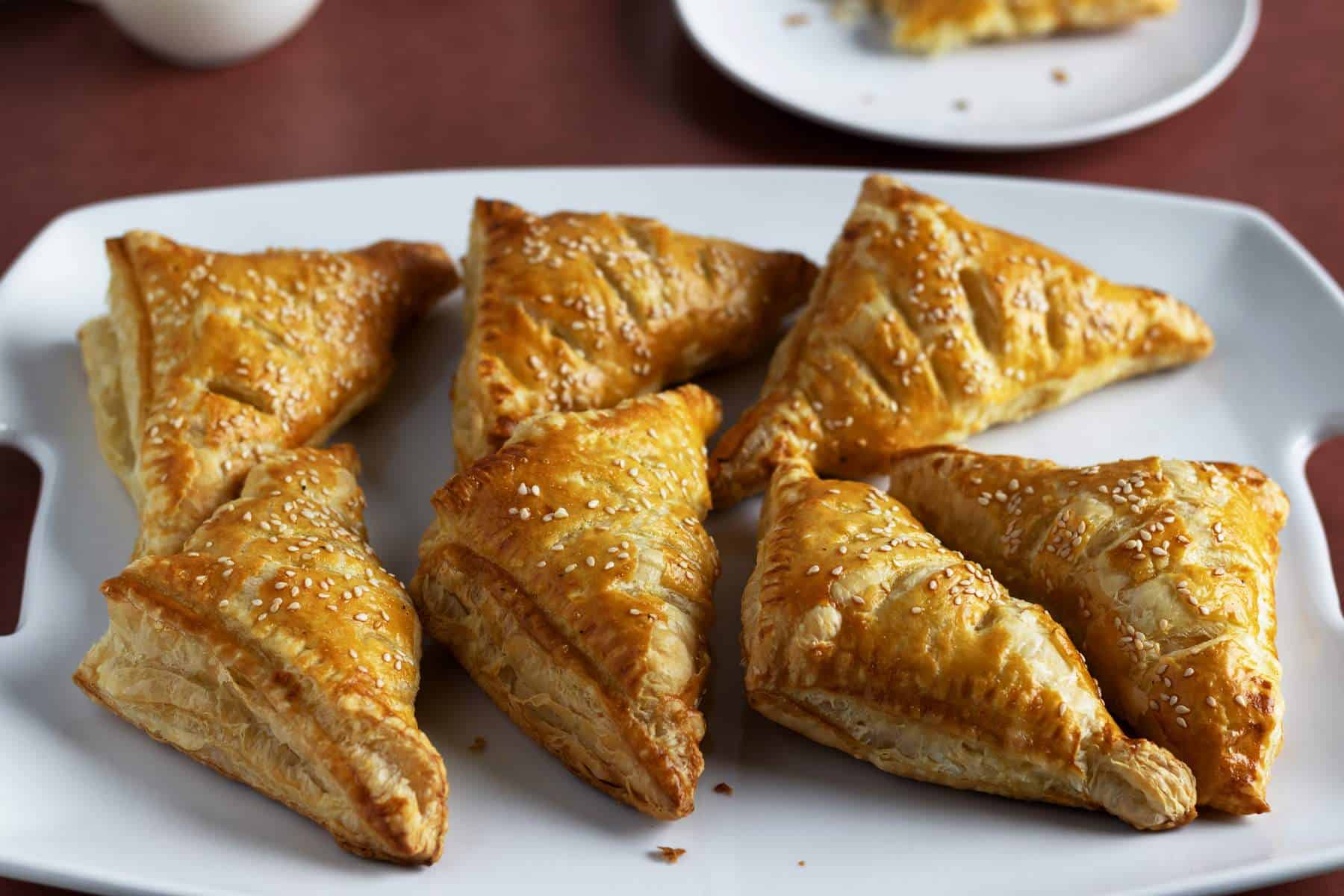 Puff pastry turnovers on a serving tray.