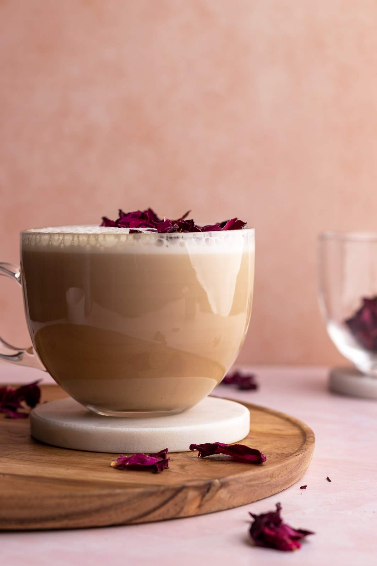 Rose latte in a mug with dry rose petals.
