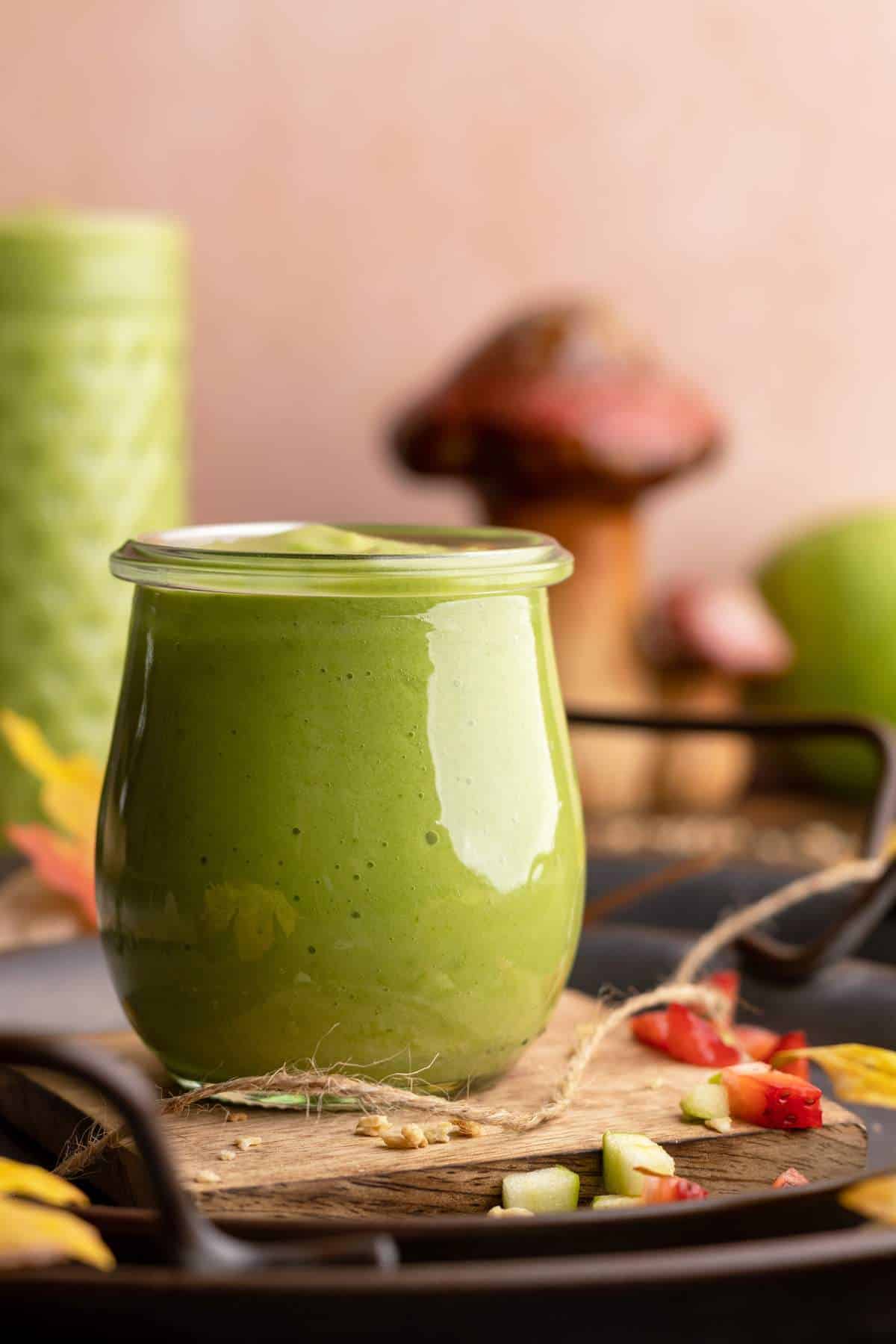 Sour apple smoothie in small jar.