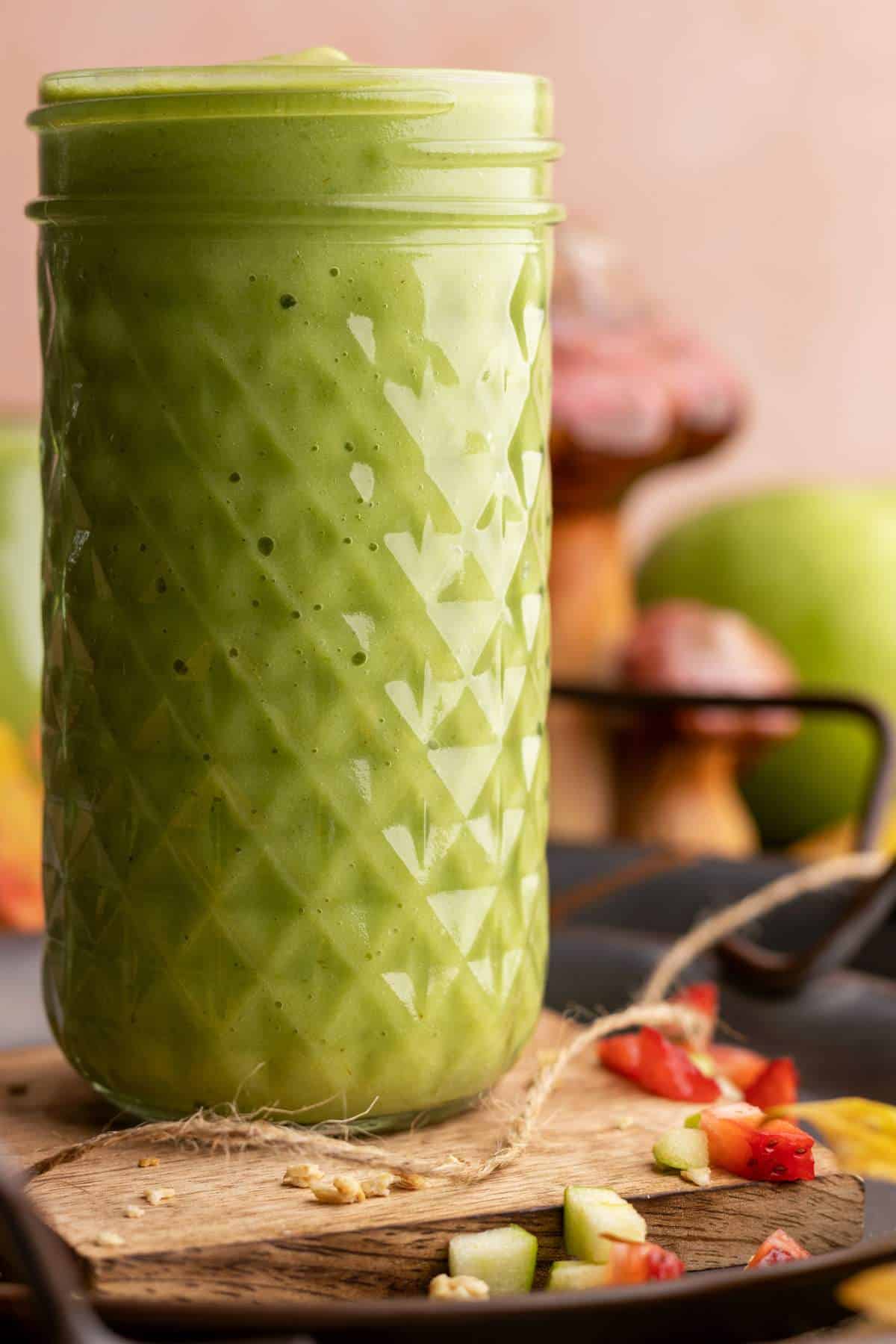 Sour apple smoothie tall jar closeup.