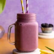 Strawberry blackberry banana smoothie in a glass jar.