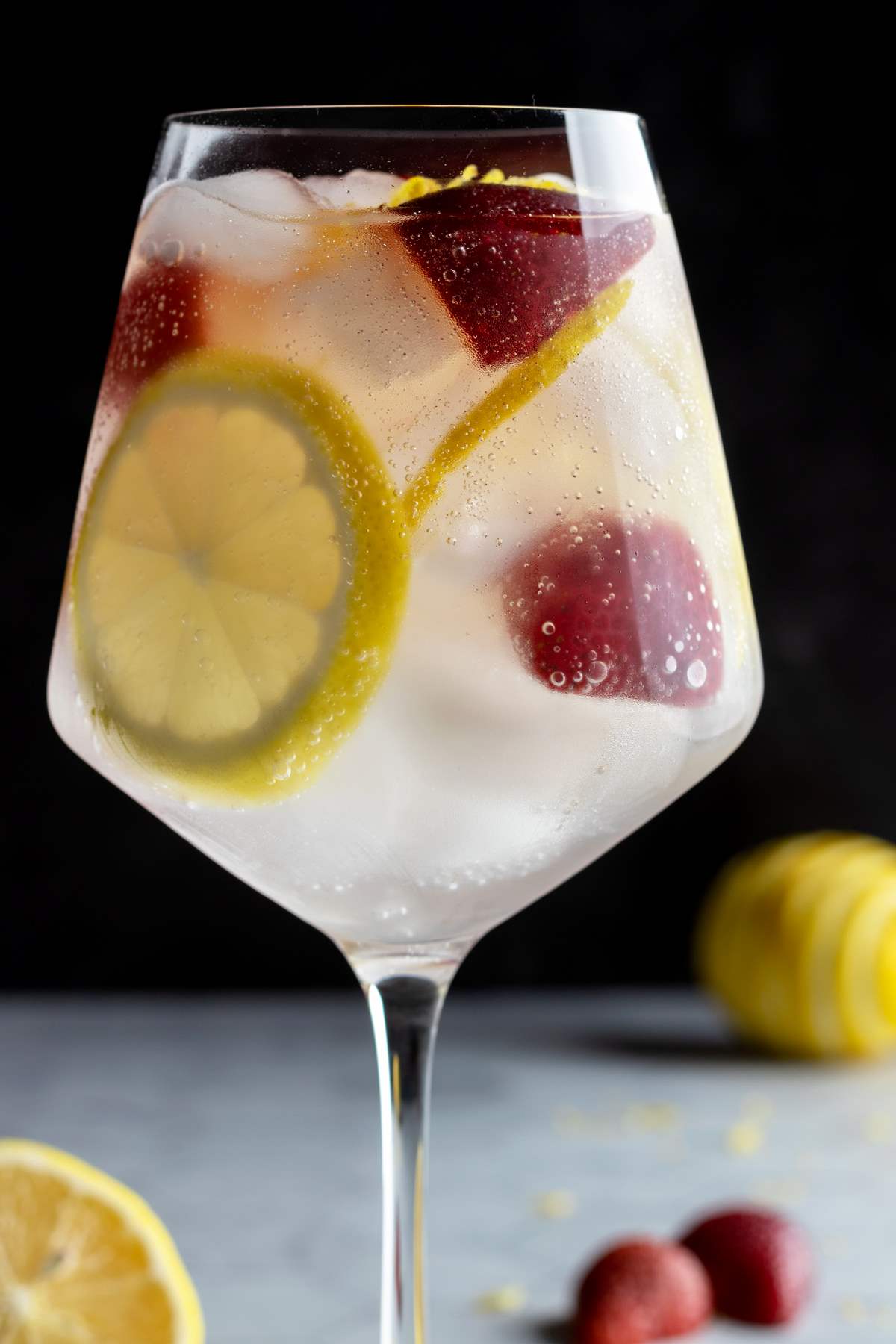 Strawberry lemon gin and tonic closeup.