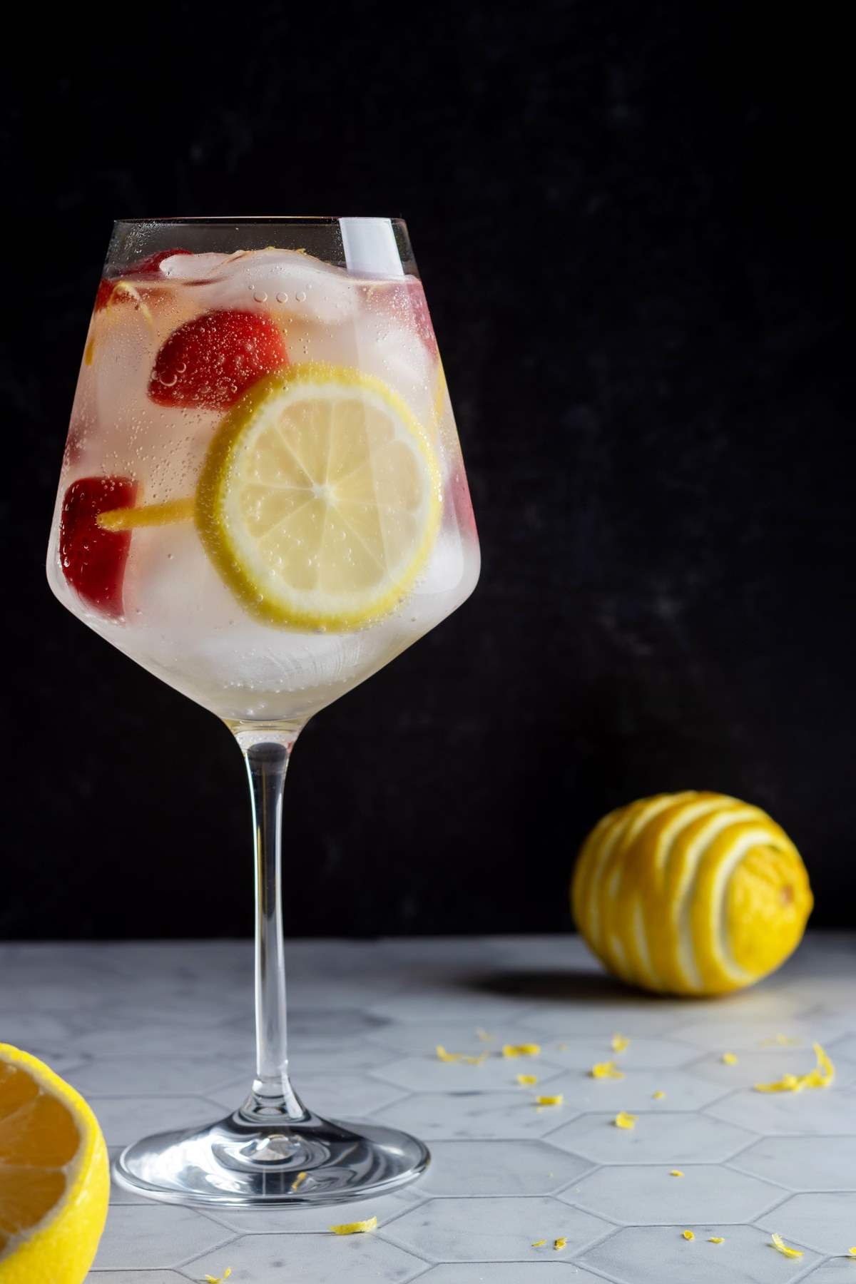 Strawberry lemon gin and tonic in a glass.