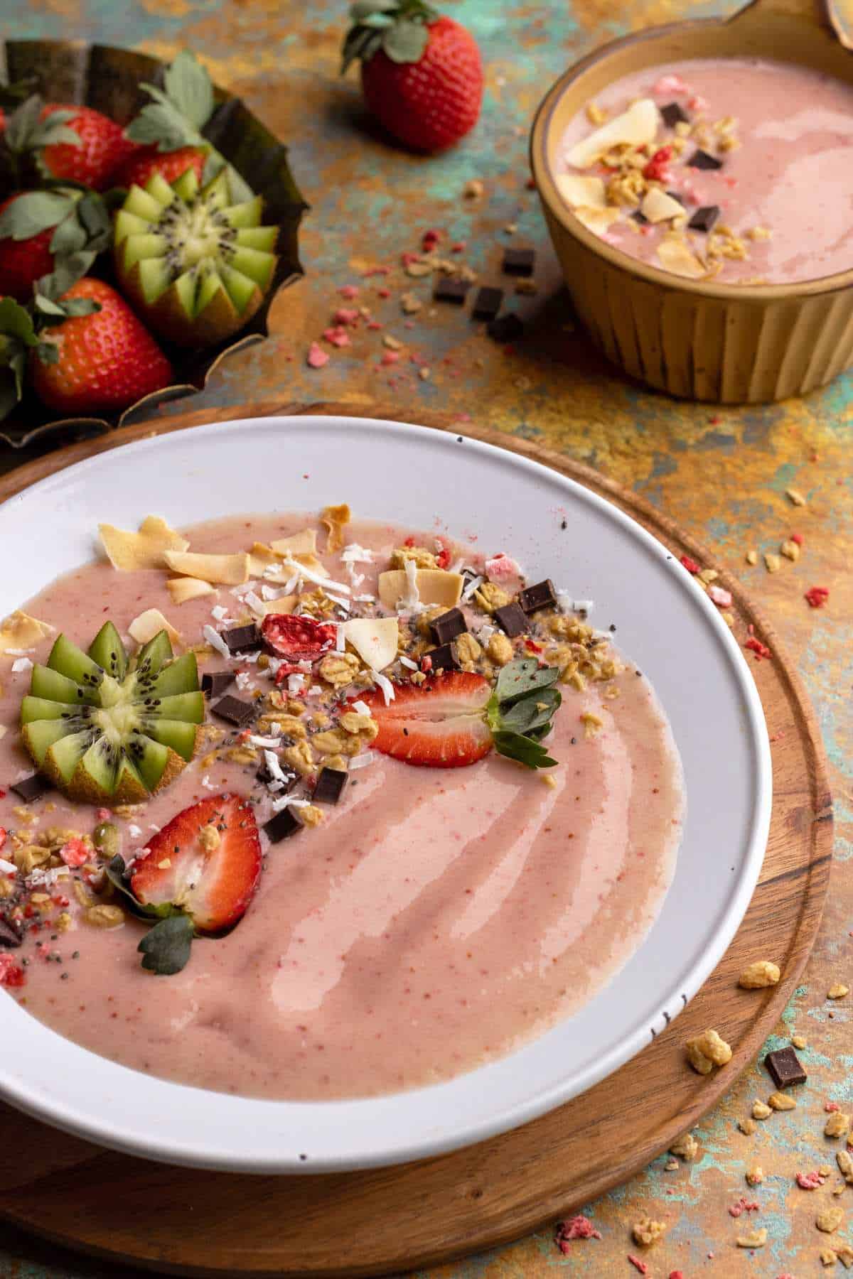 Strawberry smoothie bowl with kiwi fruit and granola.