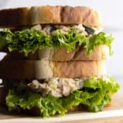 Tuna egg salad sandwich stacked head-on shot.