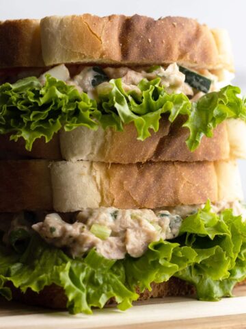 Tuna egg salad sandwich stacked head-on shot.