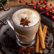 Dirty chai latte on a tray with garnishes.