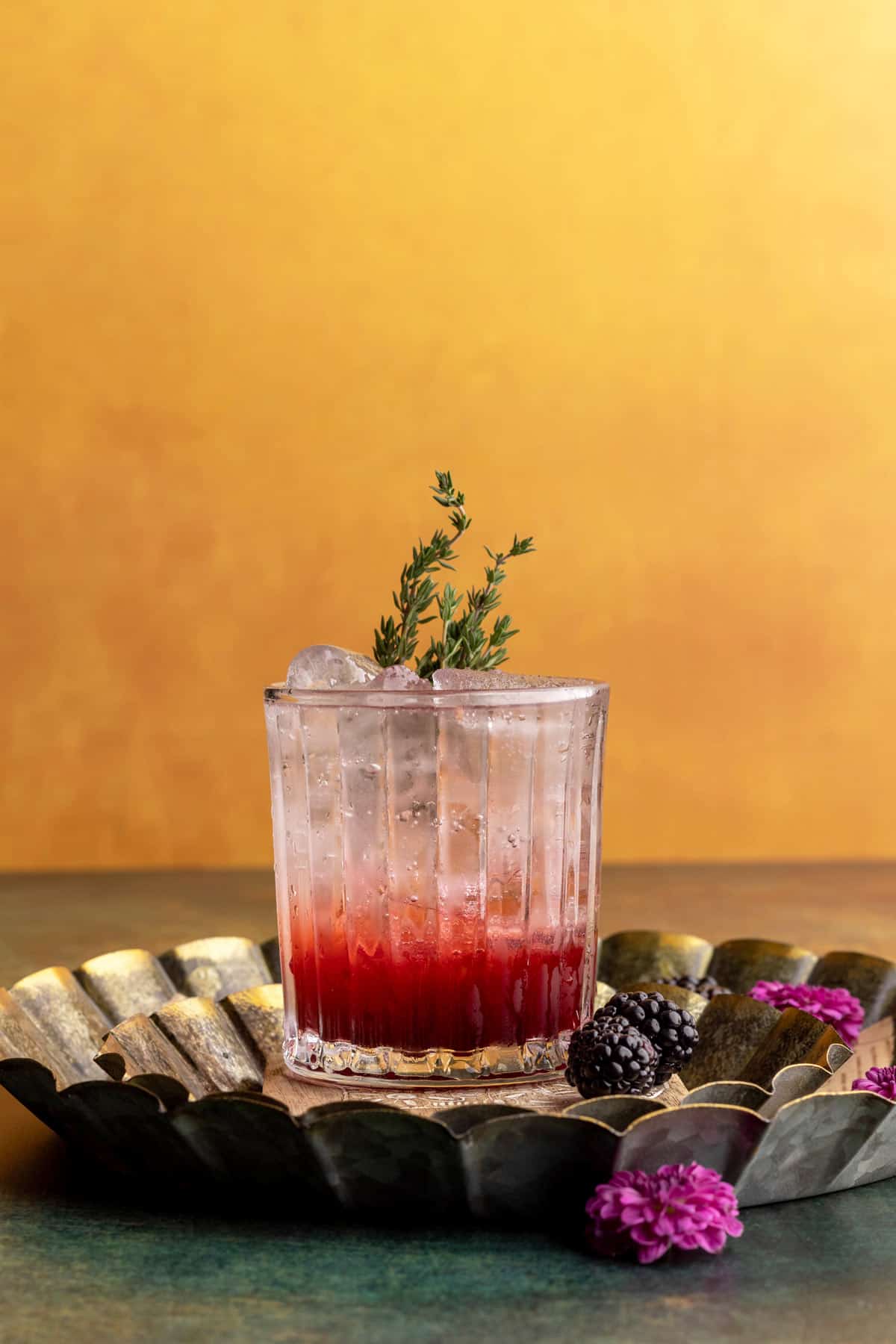 Blackberry mocktail with thyme as garnish head-on.