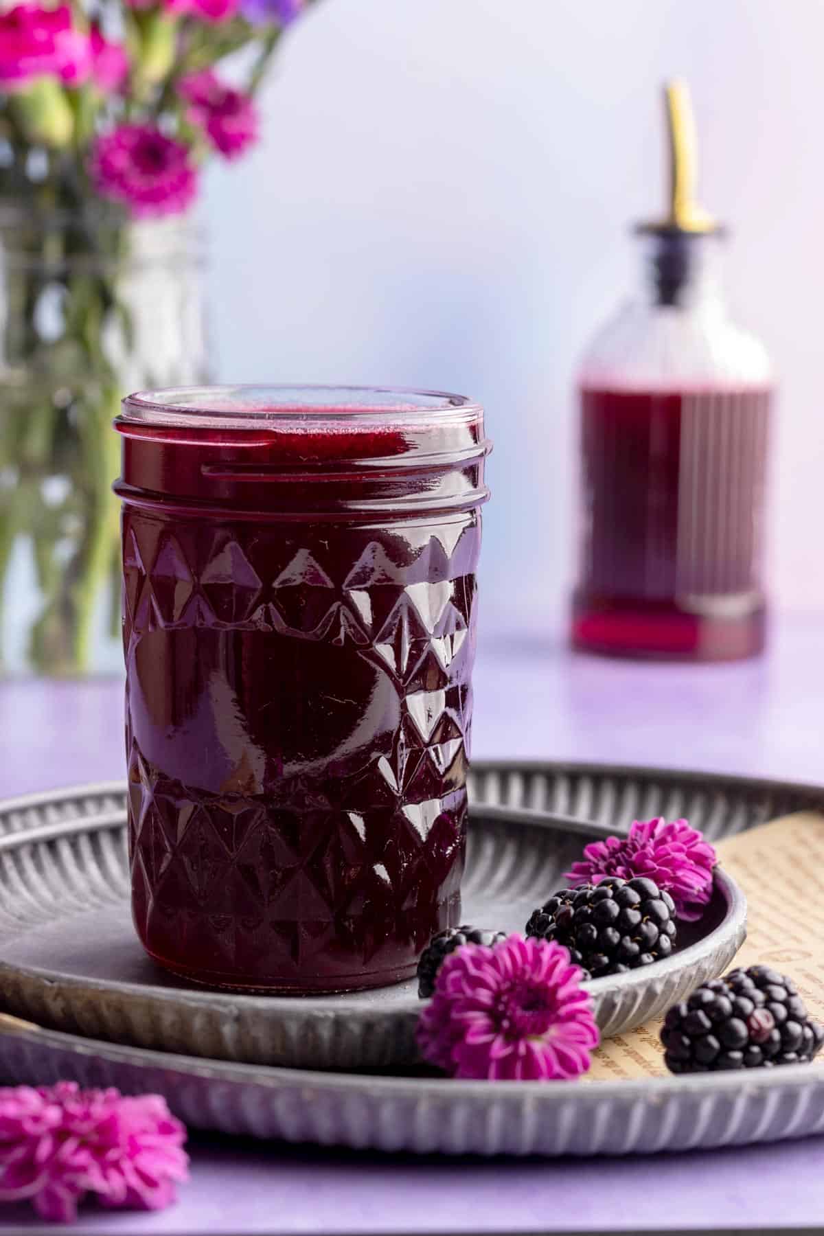 Blackberry simple syrup in a jar head-on shot.