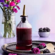 Blackberry simple syrup in dispenser.
