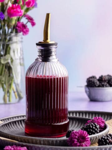Blackberry simple syrup in dispenser.