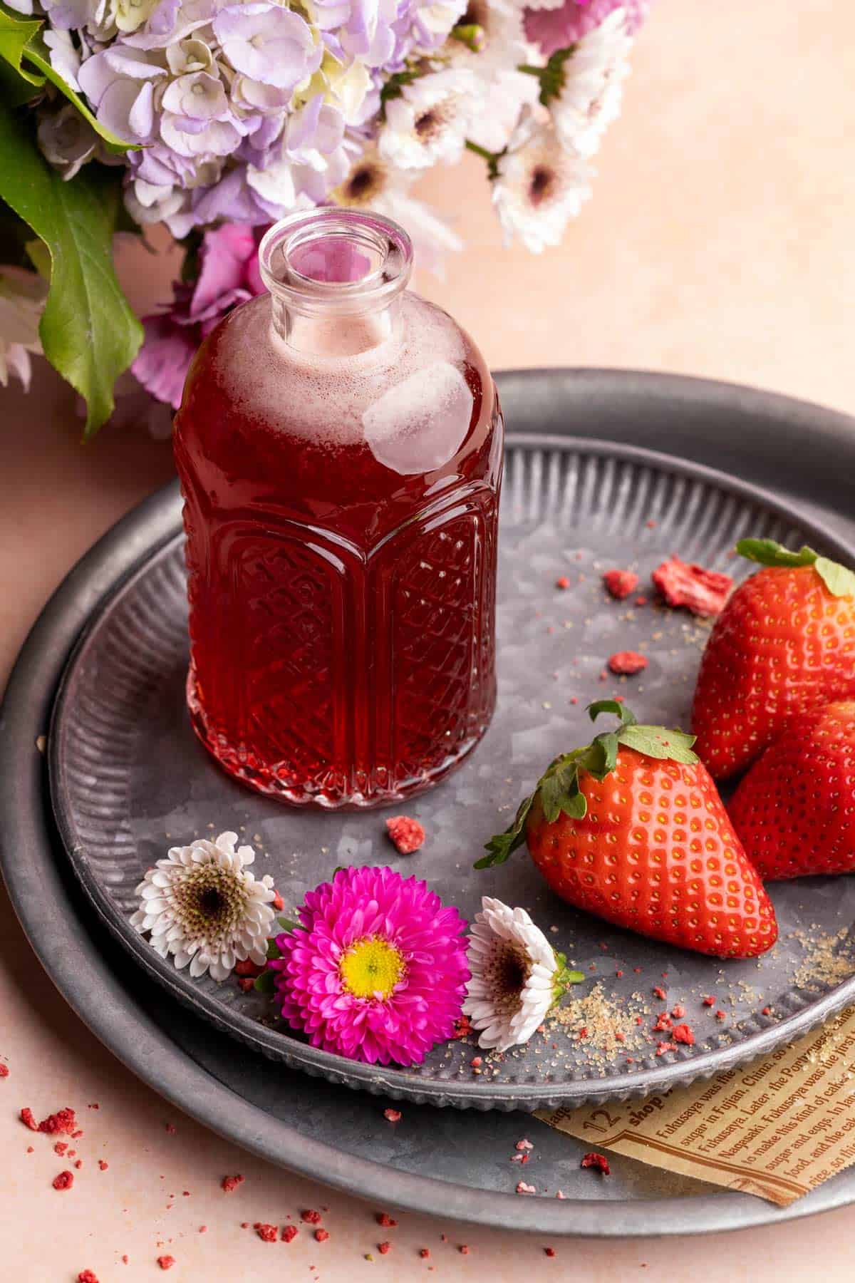Strawberry simple syrup on a metal tray.
